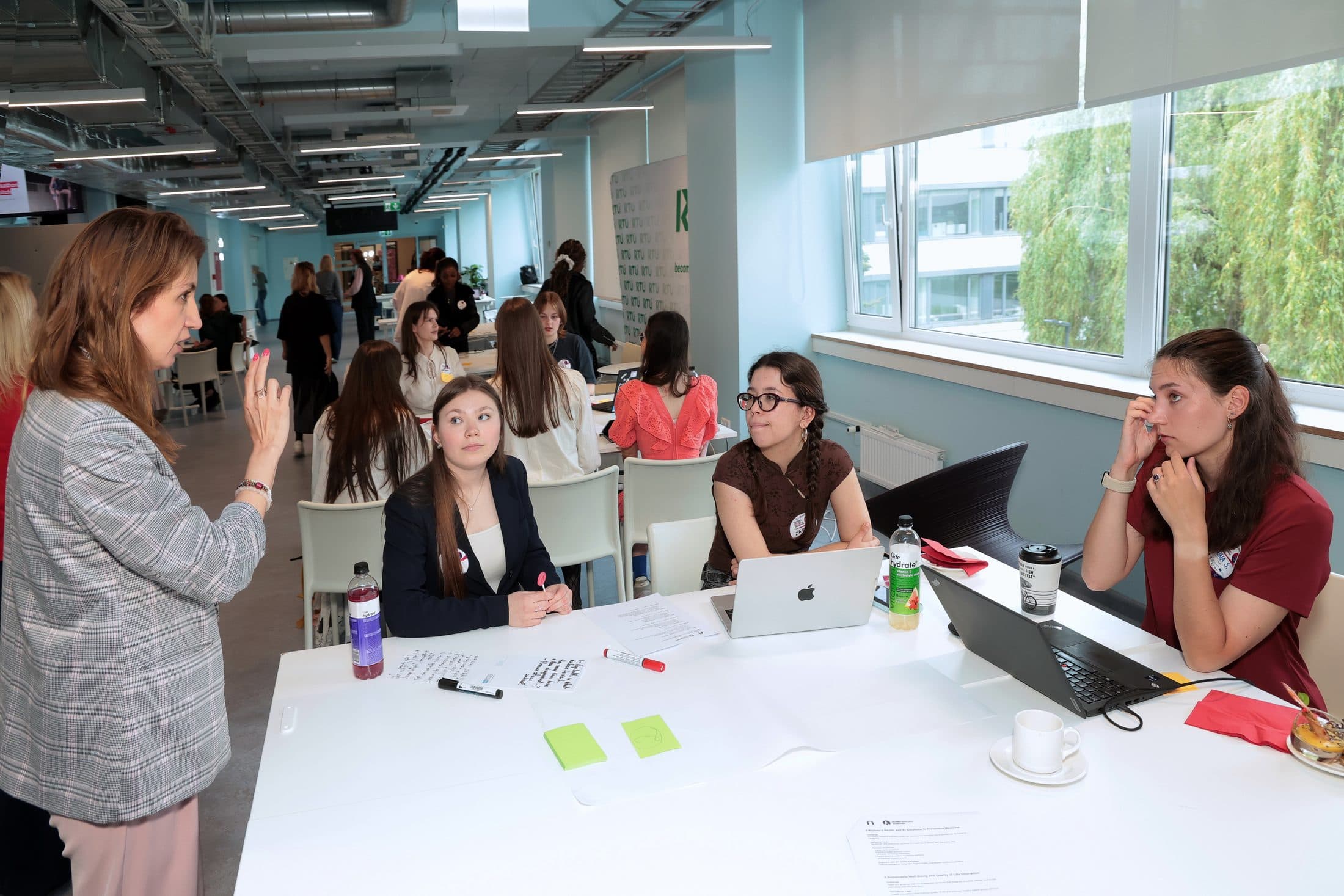 A mentor working through a business plan with founders at their table