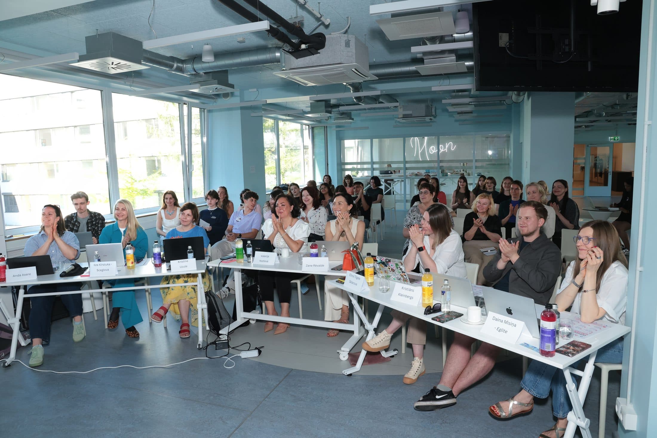 The jury applauding a team's pitch at the Women's Health & Well-being Hackathon